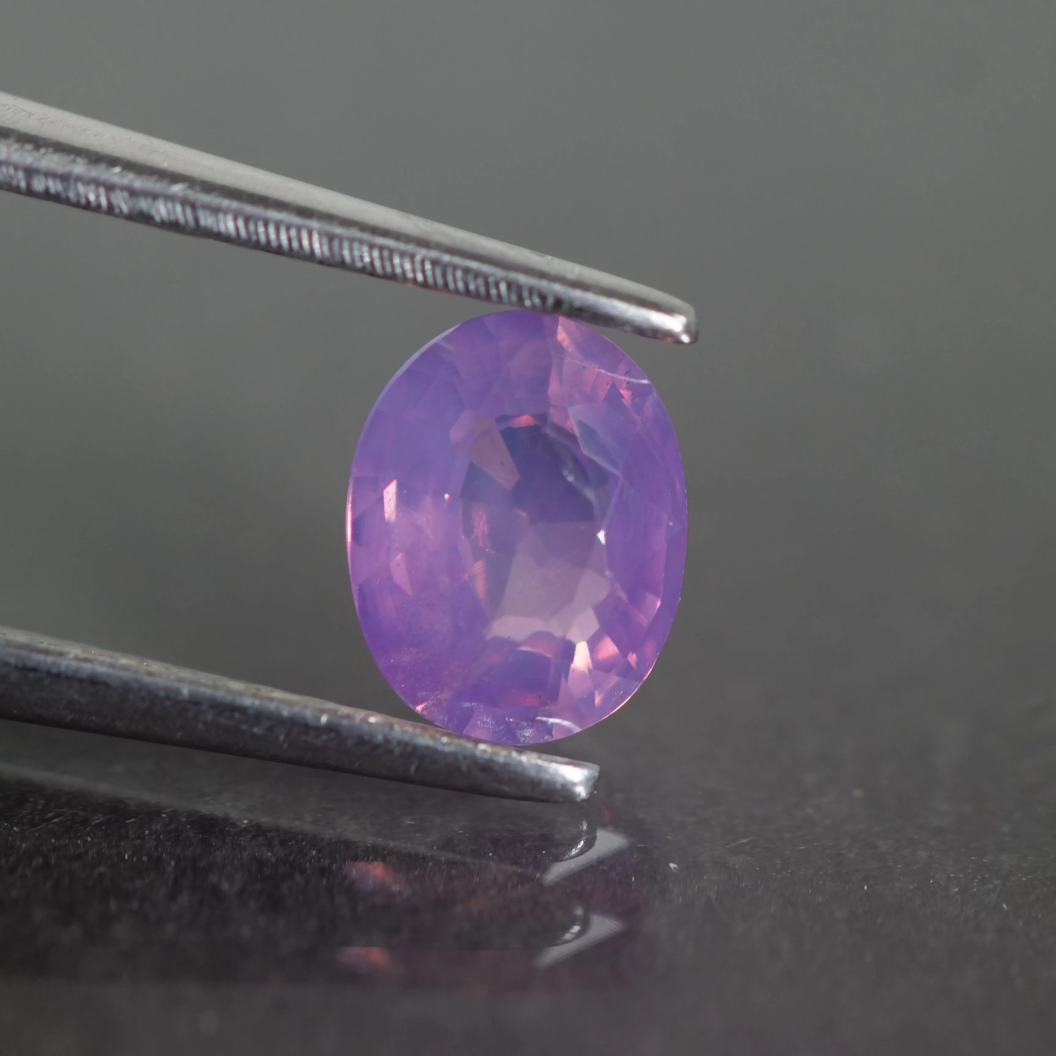 Sapphire opalescent | natural, pinkish purple, oval cut 6.4x5mm, VS 0.87ct