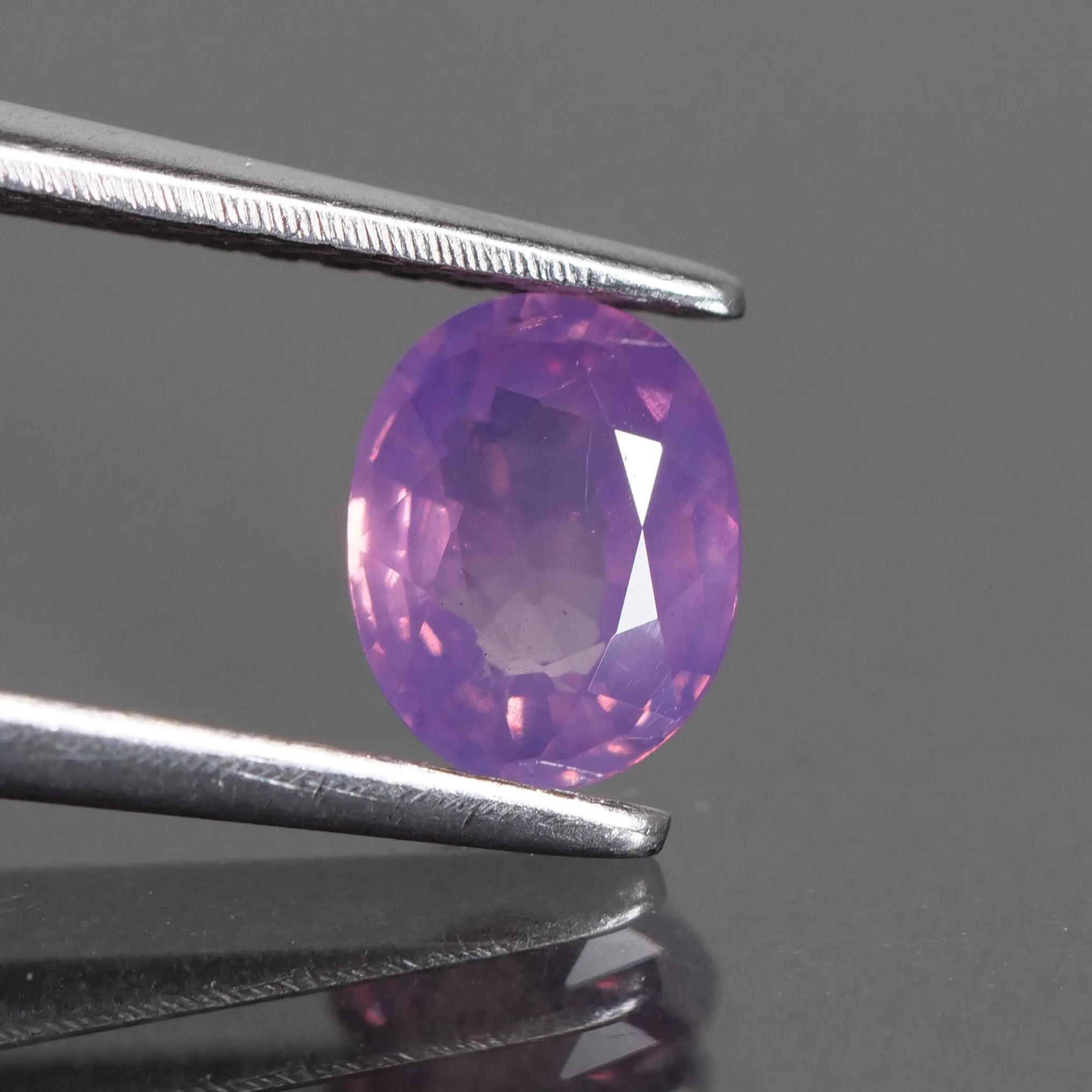 Sapphire opalescent | natural, pinkish purple, oval cut 6.4x5mm, VS 0.87ct